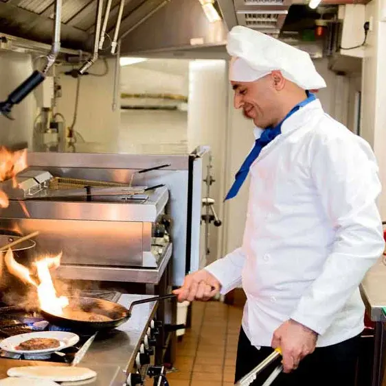Scholl Canyon Estates Chef Created Meals, chef frying a dish.
