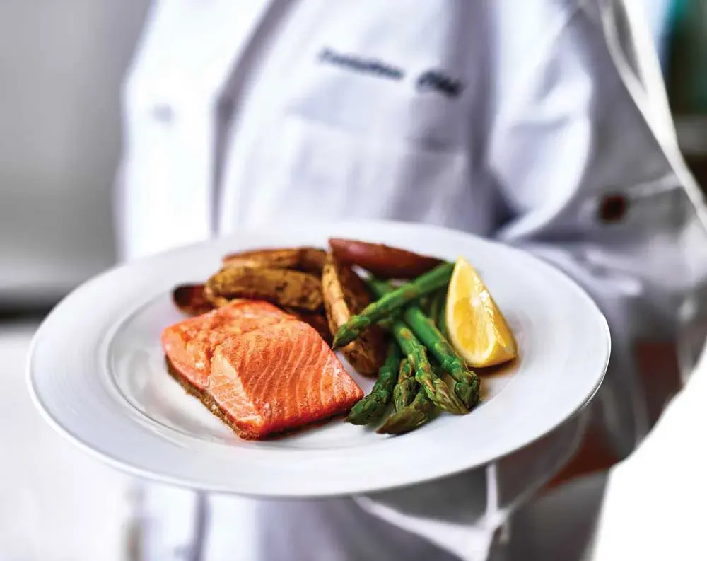 Scholl Canyon Estates Chef Created Meals, chef delivering a finished dish.