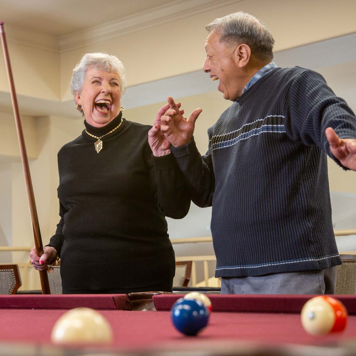 Residents playing billiards at Scholl Canyon Estates